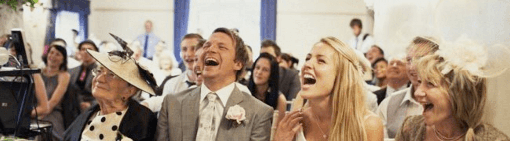 A delighted laughing wedding party
